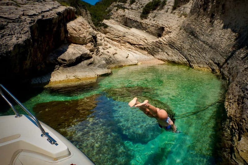 From Hvar: Blue Cave and Pakleni Islands Group Tour - Stiniva Bay, swimming inside a natural notch