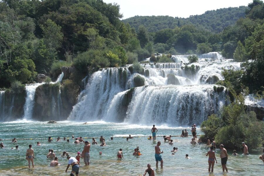 From Omiš: Krka Waterfalls and Trogir Small Group Tour - Walking the wooden trail at Skradinski Buk