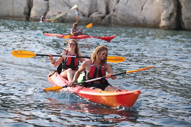 Half-Day Split Sea Kayak Adventure - Paddling past the coves and rock formations