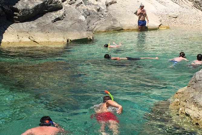 Private Blue and Green Cave Tour from Hvar Town - Stiniva Cove through the rocky entrance